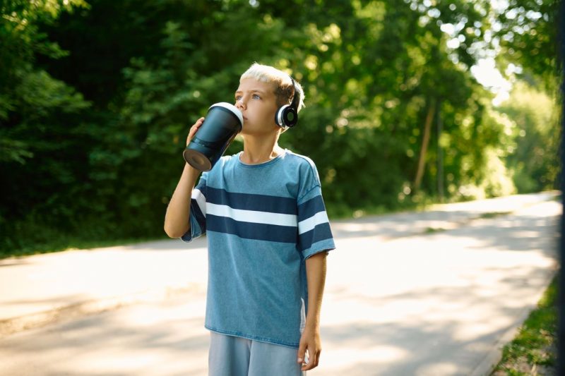Kid drinking a bottle of water