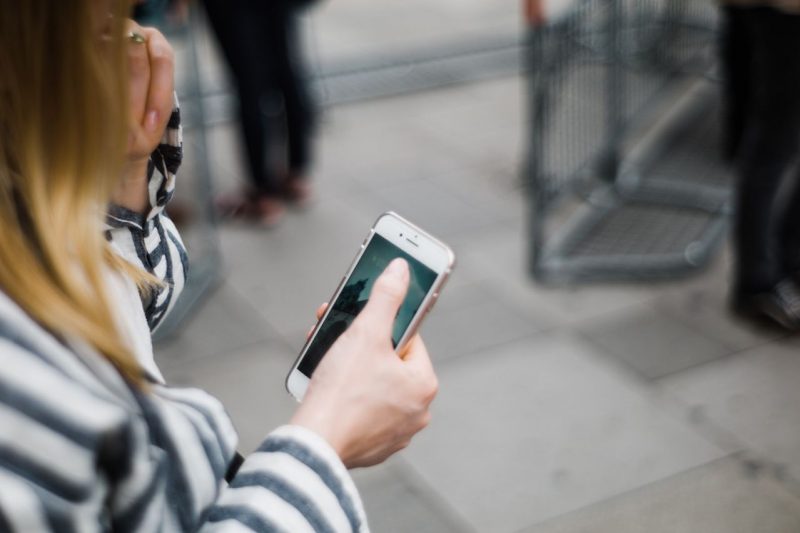 Person on a cellphone checking road conditions