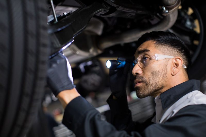 Lexus tech checking a tire