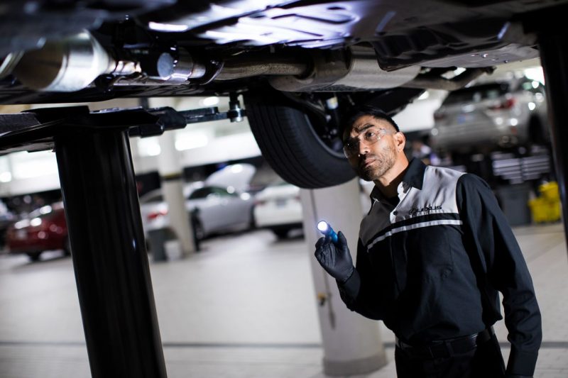 Lexus tech doing a vehicle inspection
