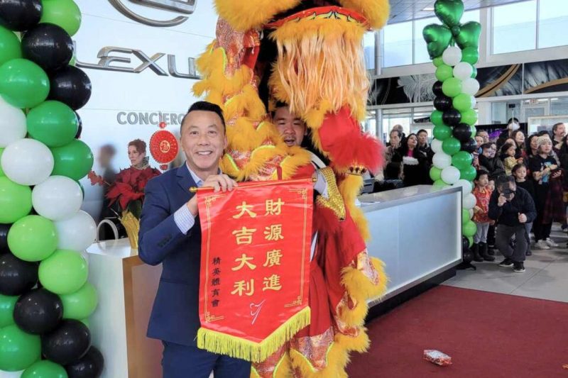 Staff members at Lexus South Pointe pose with Chinese Lion dancers.