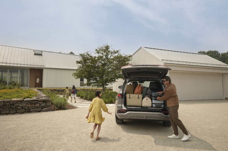 A family loads luggage into a Lexus SUV vehicle.