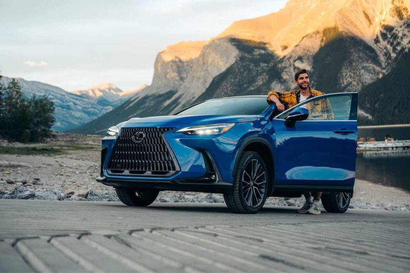 A man climbs out of a blue Lexus NX 350h.