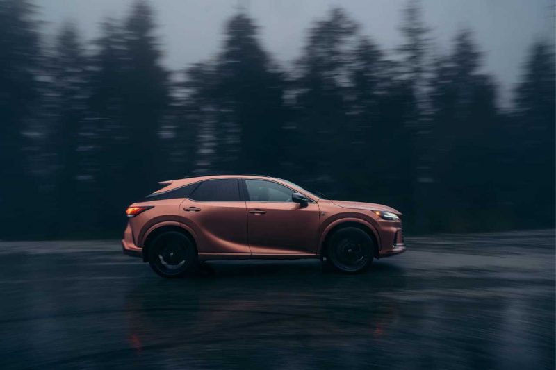 The Lexus RX 500h drives down a foggy, dark road.