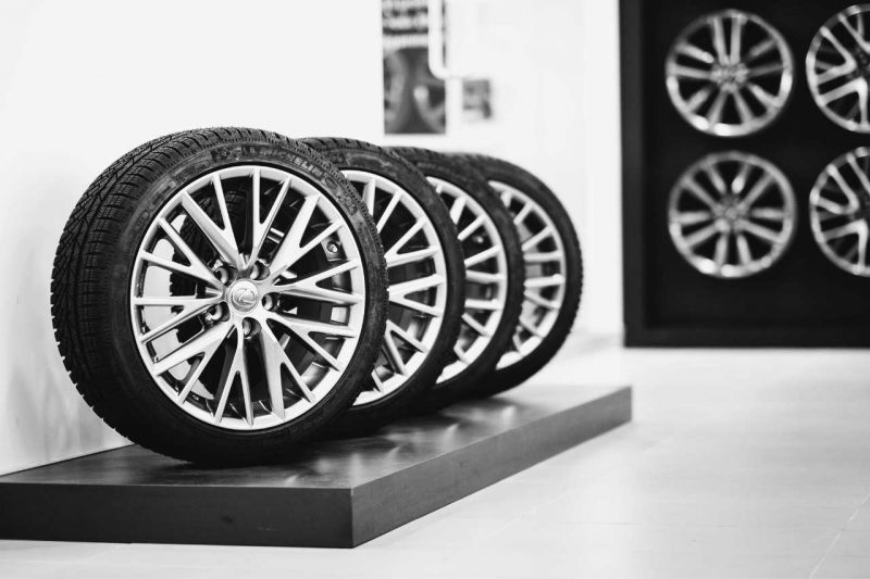Brand new seasonal Lexus tires in a vehicle showroom.