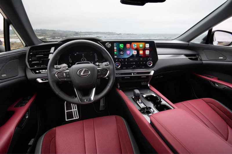 The red interior of a Lexus RX SUV, looking out the windshield towards a foggy landscape.